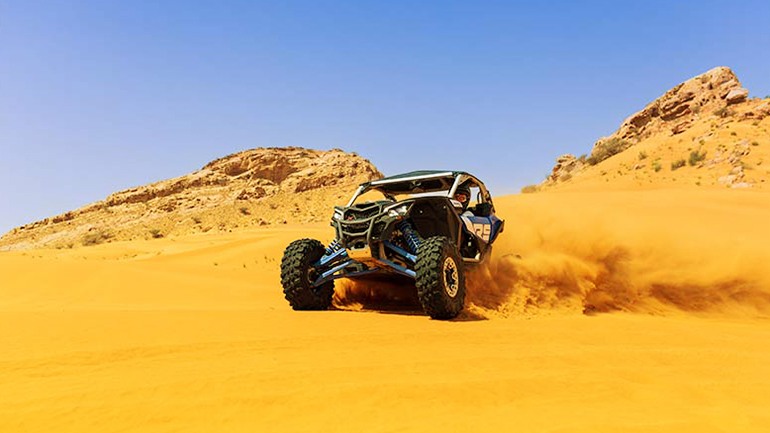How can you explore the Dubai desert on a dune buggy?